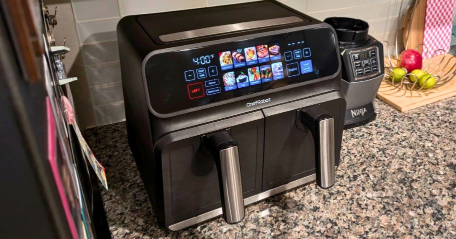 a black and silver dual basket large air fryer with a visual touch display on a counter 