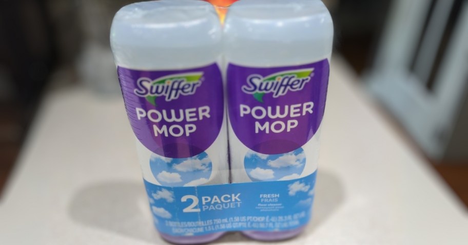 a 2 pack of Swiffer Powermop refill bottles in Fresh scent wrapped in plastic on a counter