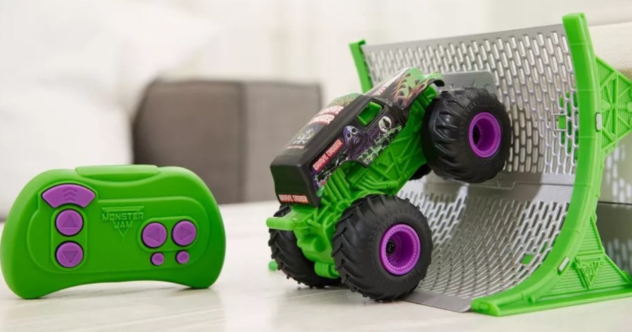 a green and purple Monster Jam Gravedigger remote control monster truck and remote with a ramp