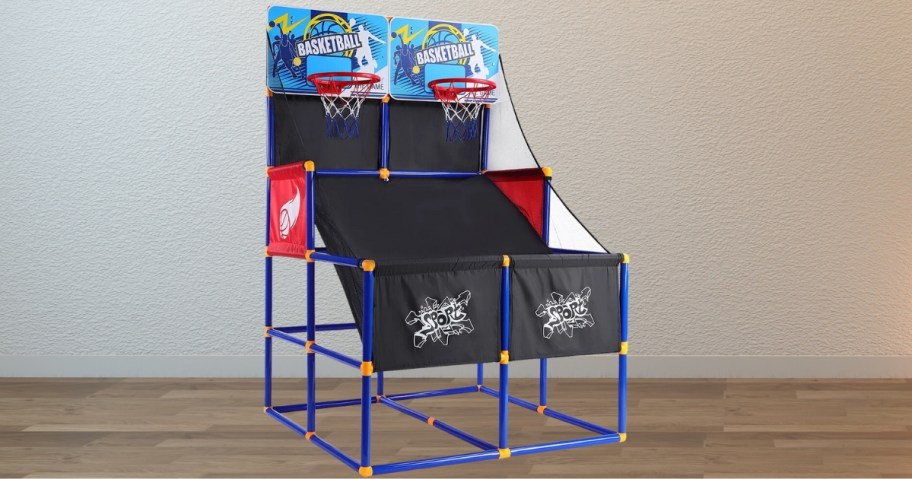 a basketball arcade game with 2 shotting sections and hoops sitting in a living room