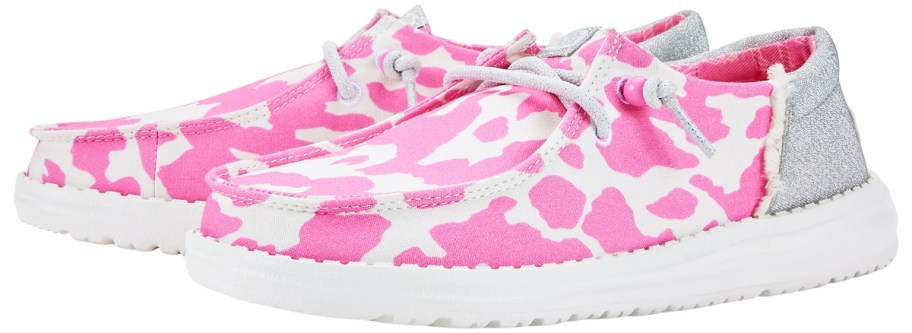 pair of pink and white cow print sneakers