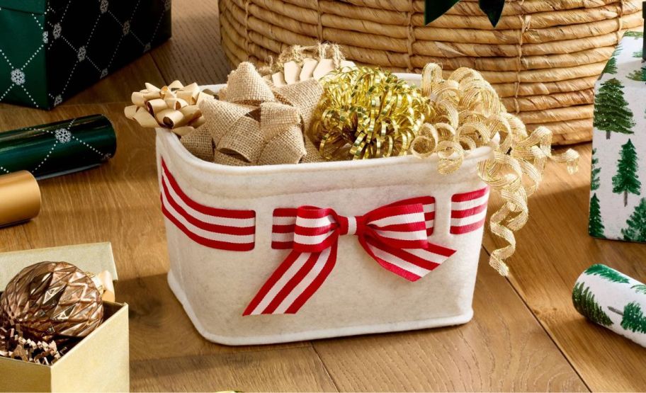 white fabric basket with a red and white striped grosgrain bow