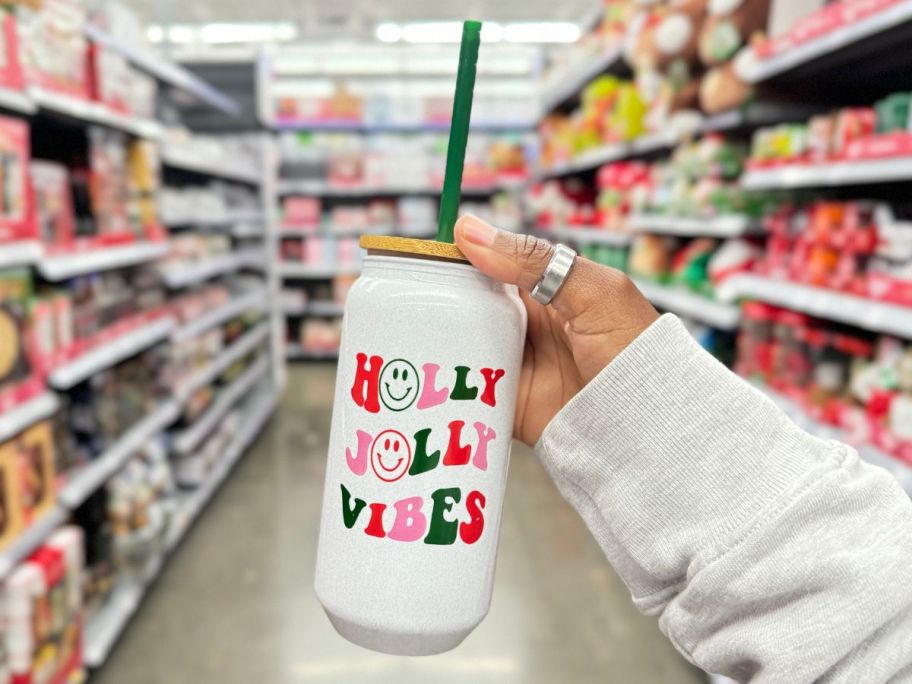 Holiday Time Holly Jolly Vibes 20oz Tumbler in hand in store