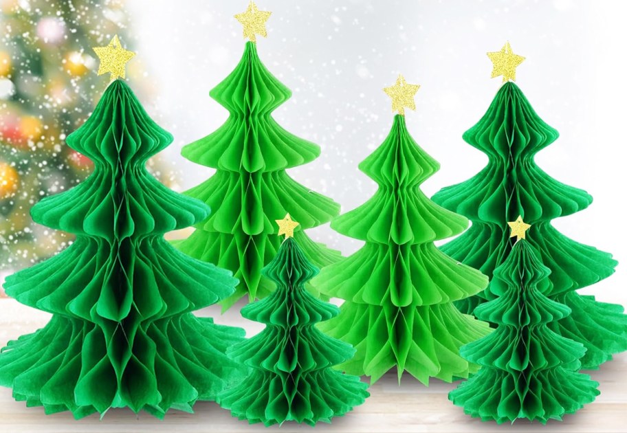 green paper christmas trees with gold stars on top