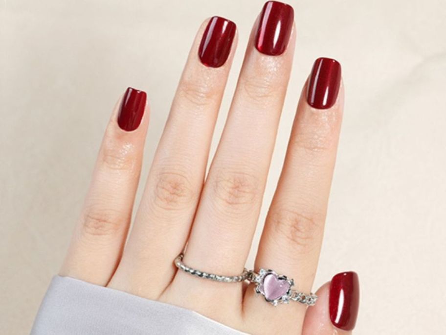 Woman's hand wearing Jofay Red Short Square Press on Gel Nails