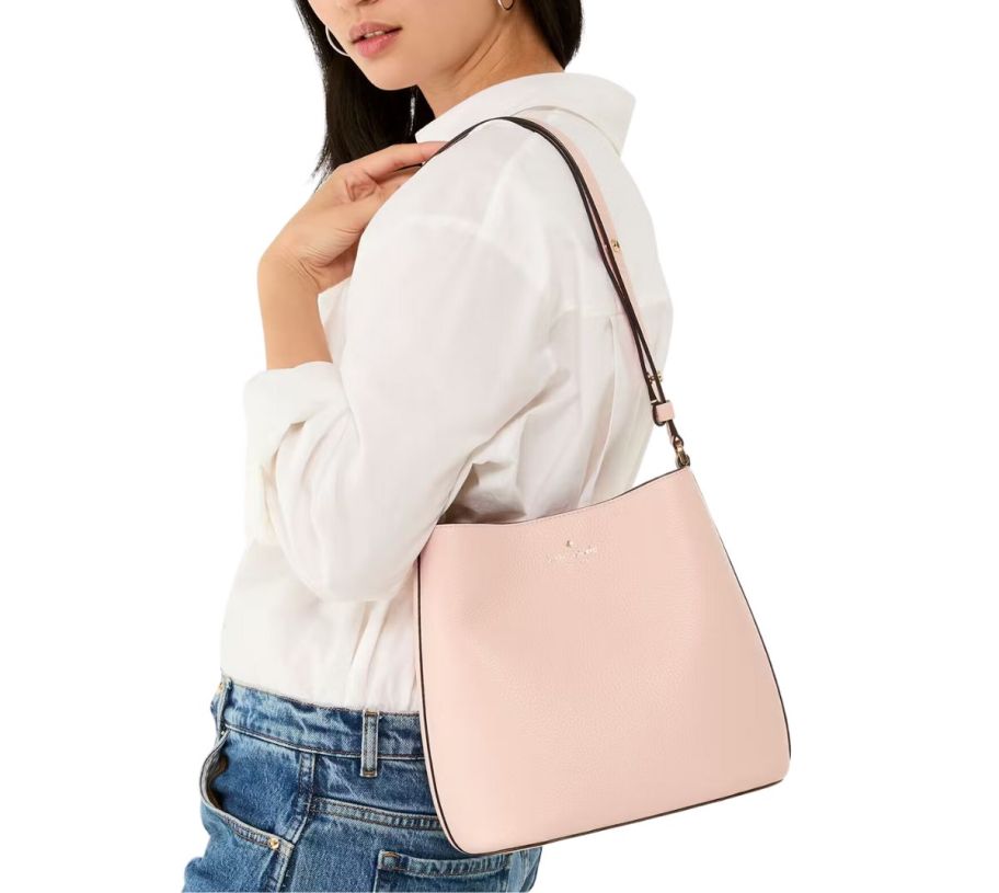 a woman wearing a pink shoulder bag