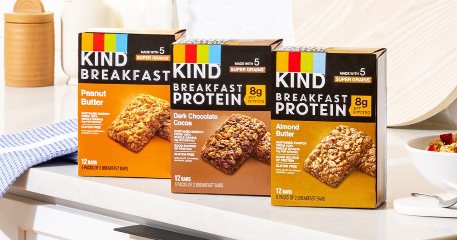 three boxes of KIND Breakfast Protein Bars on kitchen counter