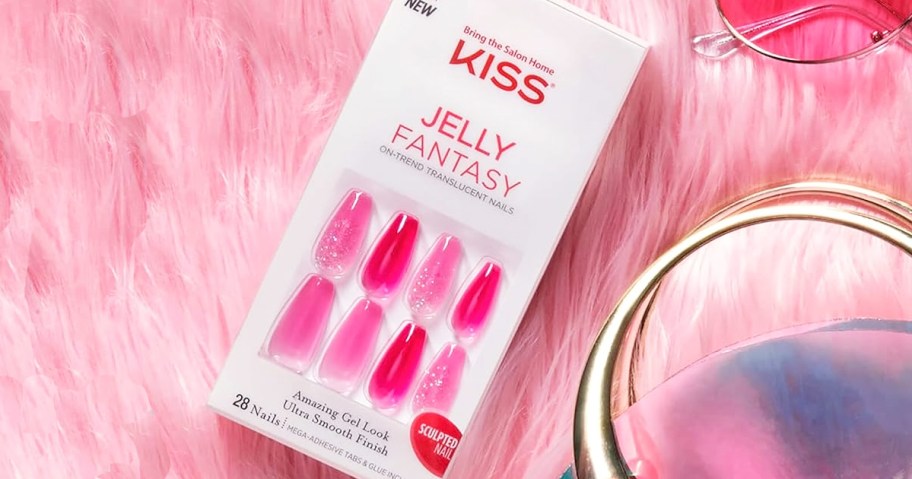 box of pink jelly press-on nails on a pink furry blanket