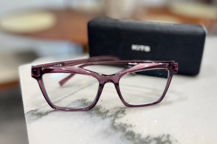 purple glasses next to black box