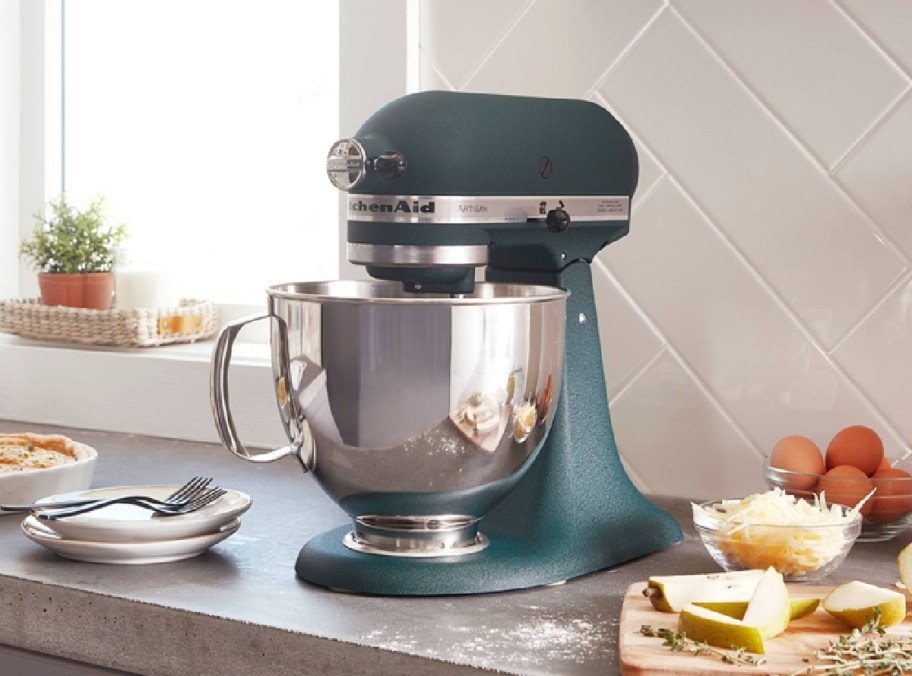 KitchenAid Artisan 10-Speed Stand Mixer displayed in a kitchen with food on the side