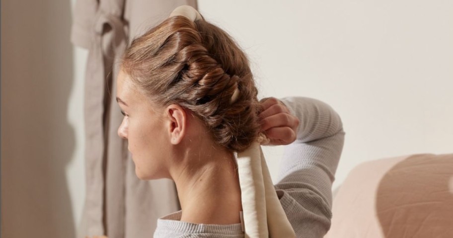 woman wearing heatless curls rod in room