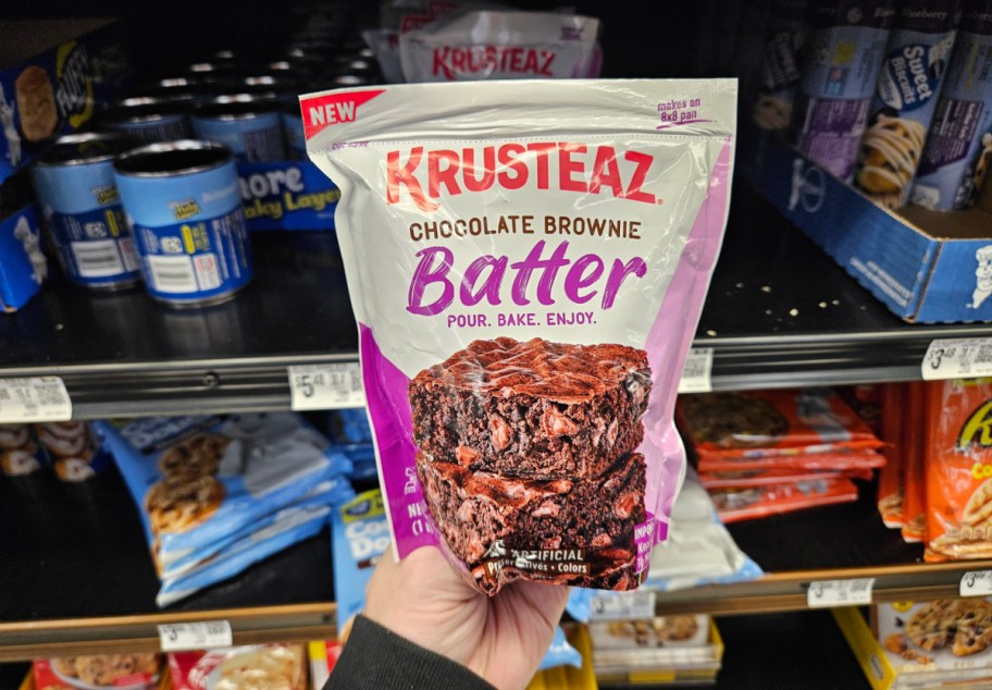 hand holding a Krusteaz Brownie Batter package