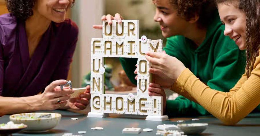 People playing with a LEGO Message Board