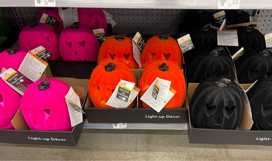 hollow felt pumpkins in black orange and hot pink on a store shelf