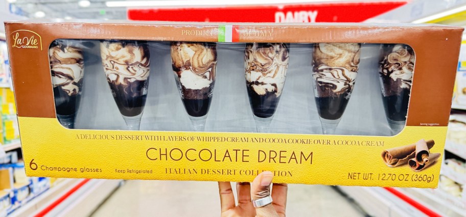 hand holding up a set of La Vie Gourmand Chocolate Dream Flutes in store