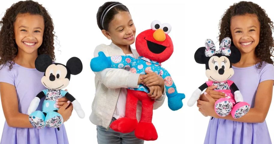 3 Little girls holding Disney and Sesame Street Plush