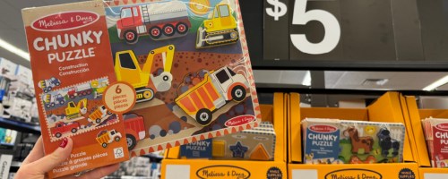 person holding up Melissa & Doug Wooden Puzzle at Walmart next to $5 signage