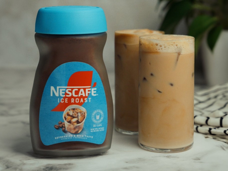 Nescafe ice roast next to two cups of coffee