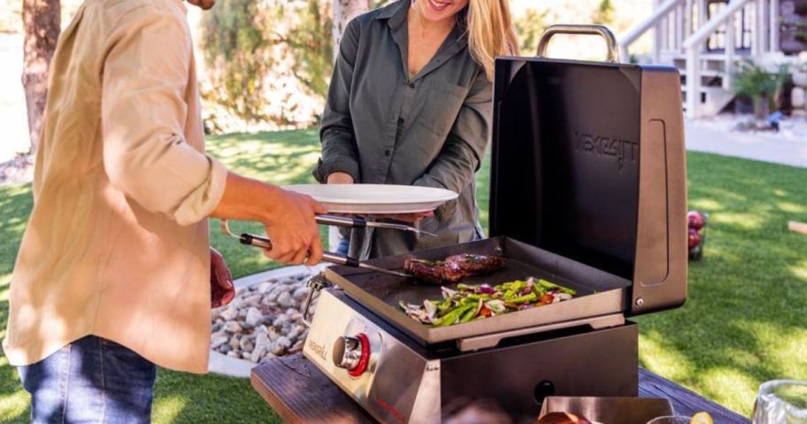 People surrounding a Nexgrill Daytona 1-Burner Propane Gas Table Top Grill