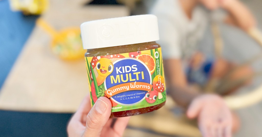 hand holding a jar of OLLY Kids Multivitamin Gummy Worms