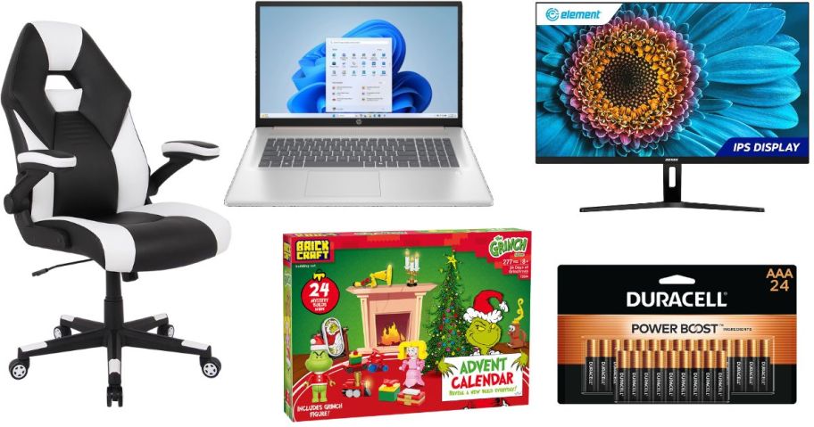 A black and white gaming chair, laptop, monitor, batteries, and Grinch advent calendar