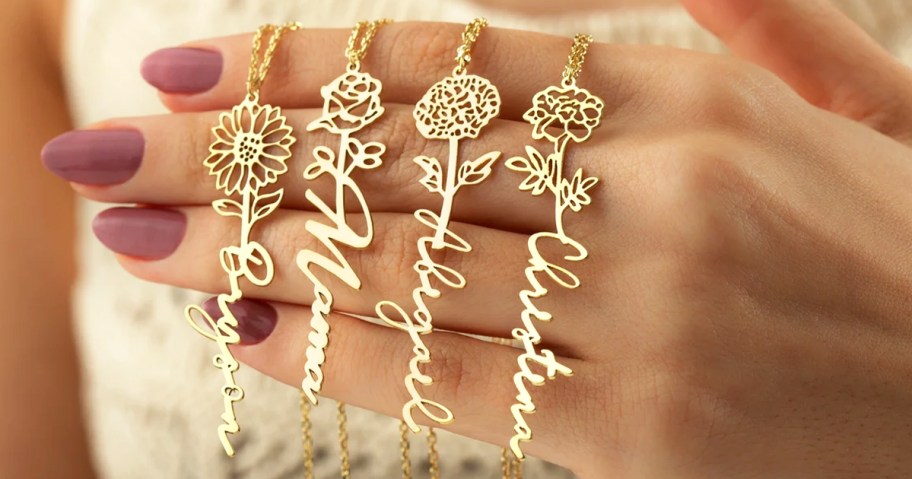 hand holding flower necklaces with names as the stems