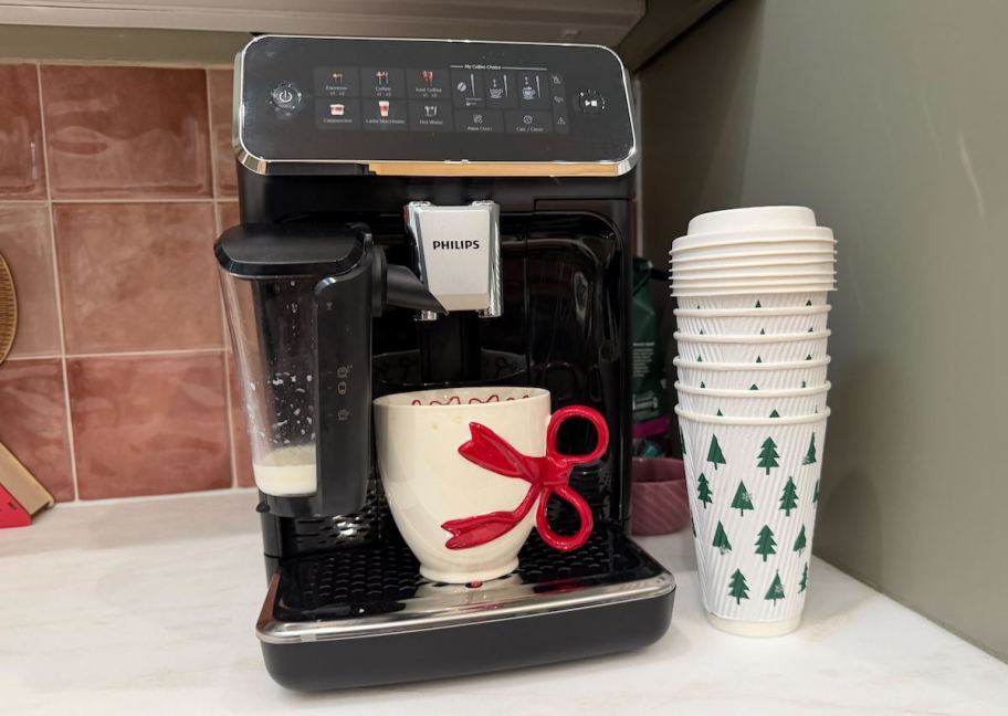 phillips coffee machine on countertop with pink backsplash