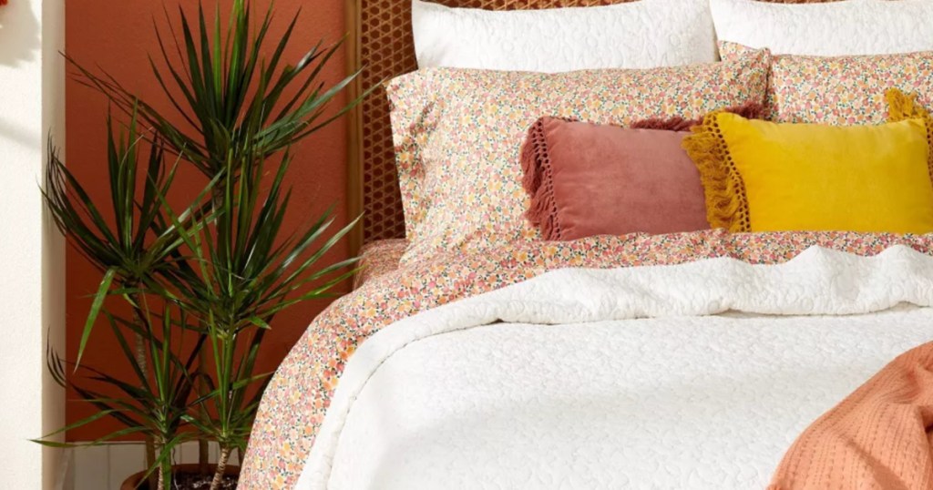 floral print sheets on bed with white comforter