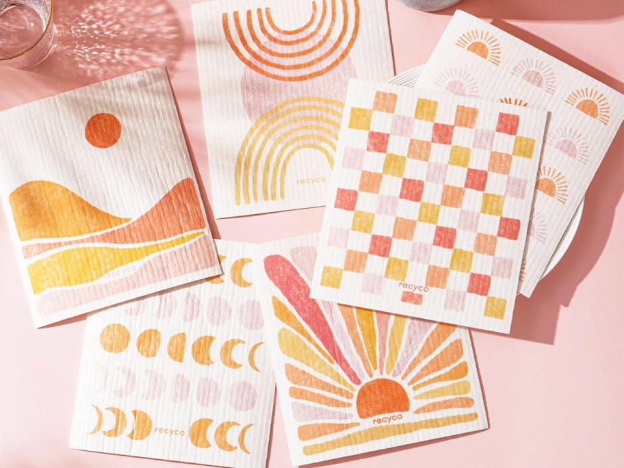 set of Swedish Dishcloths with pink and orange sun designs on them