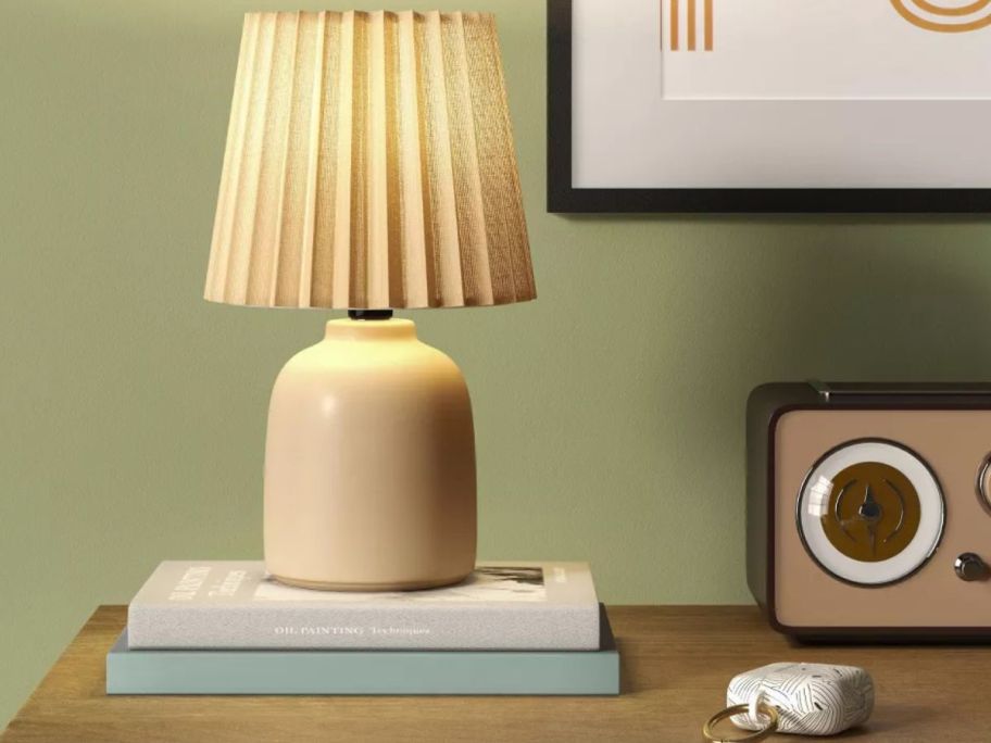 Room Essentials Mini Ceramic Lamp on a stack of books next to a vintage radio