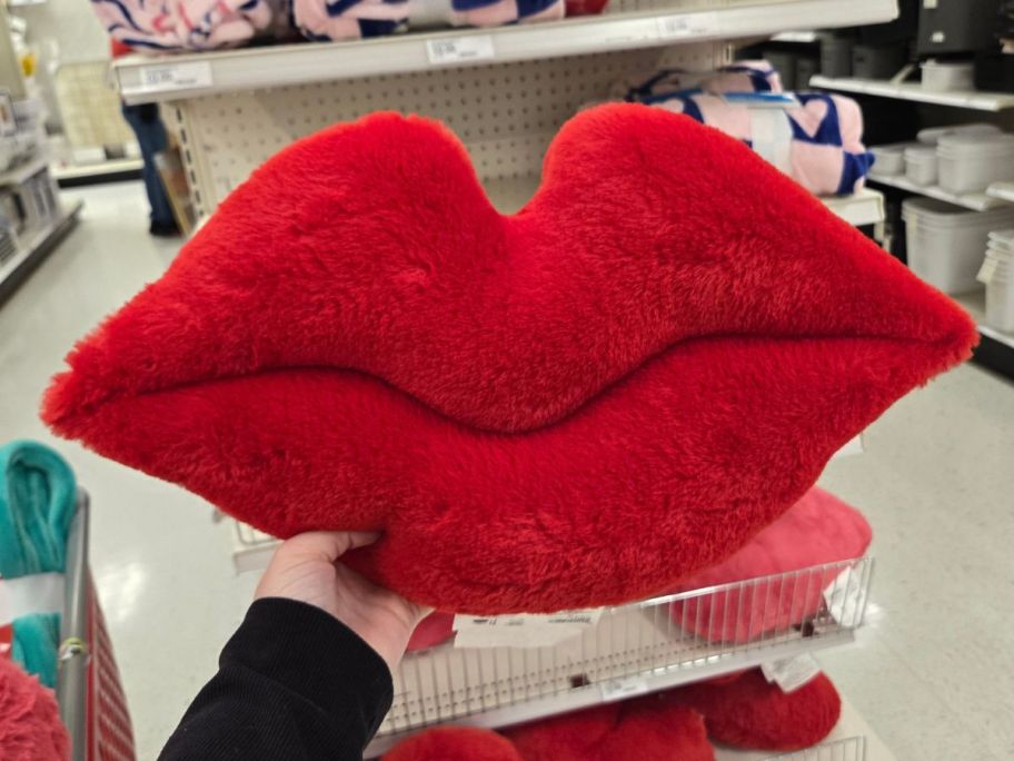 Room Essentials Plush Lip-Shaped Toss Pillow in hand in store