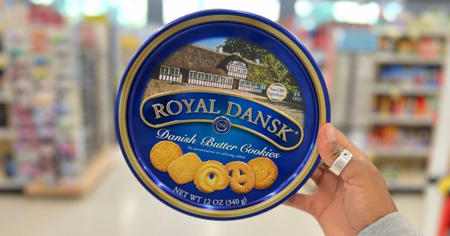 Hand holding a ton of Royal Dansk Cookies