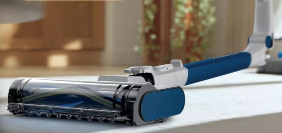 shark vacuum being used while bent on the carpet