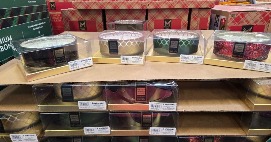 Several large 5-wick candles displayed in a store