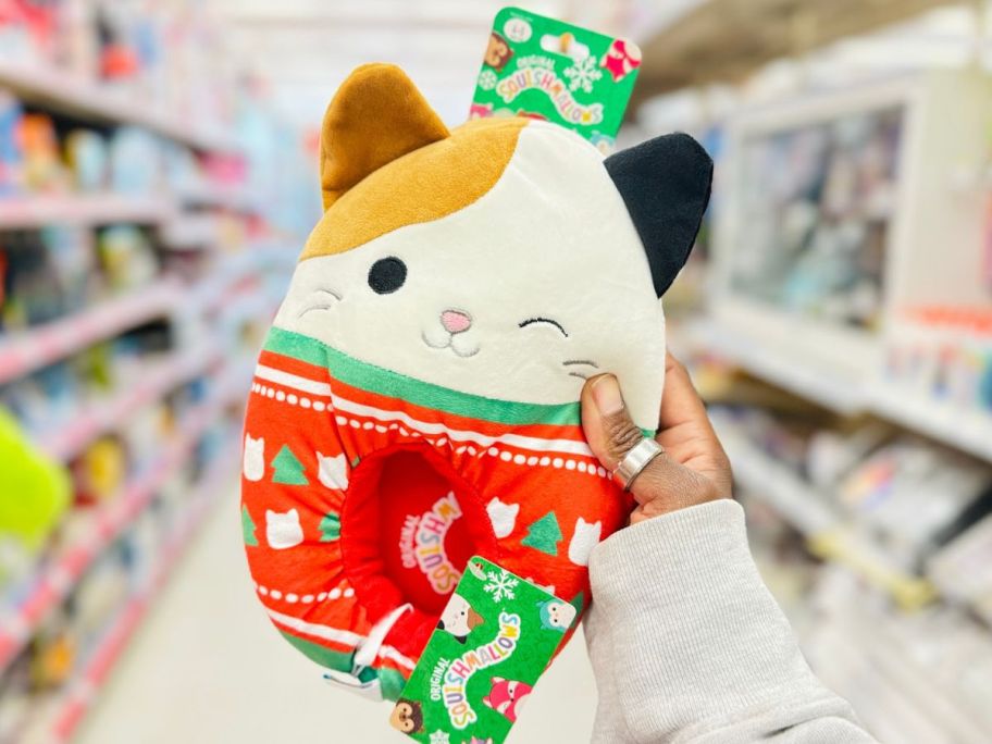 Hand holding a Holiday Cat Squishmallow slipper