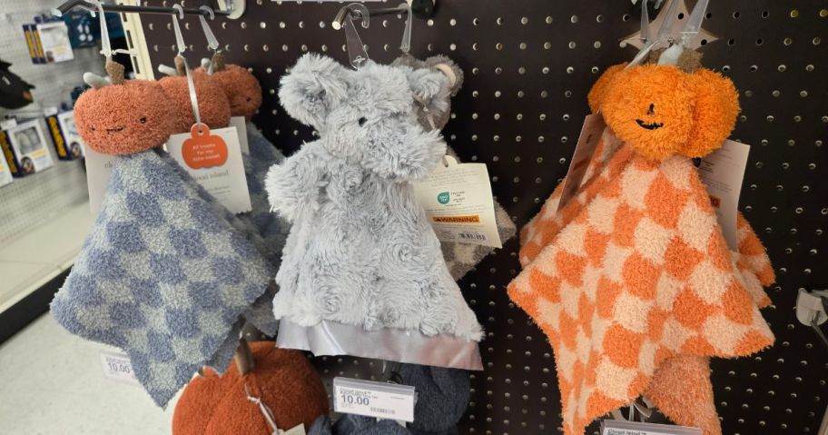 several blankets with plush characters attached to them 