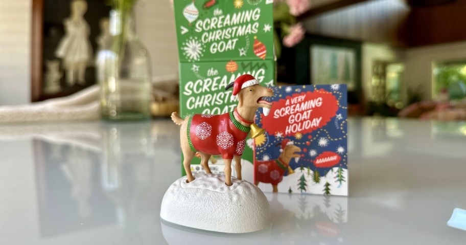 the screaming christmas goat toy with box and book