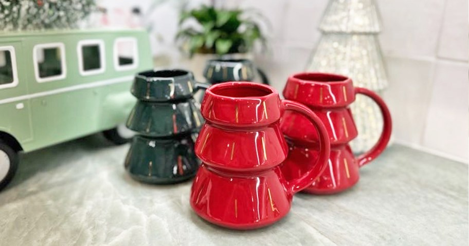 set of green and red tree shaped coffee mugs on kitchen counter