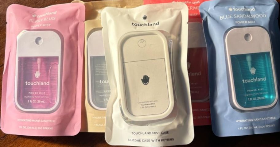 4 touchland hand sanitizers and a silicone carrying case