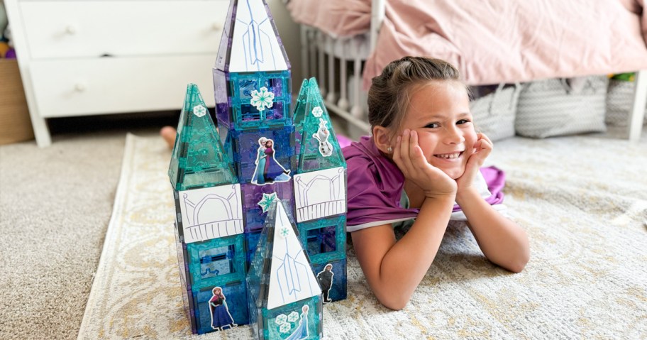 girl laying on floor next to castle build with tytan tiles frozen magnetic tiles set