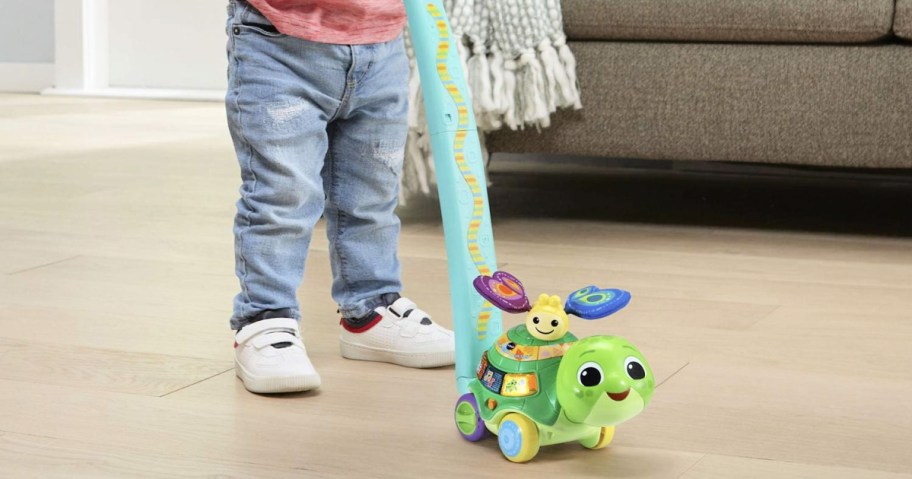 toddler pushing a VTech Toddle & Talk Turtle