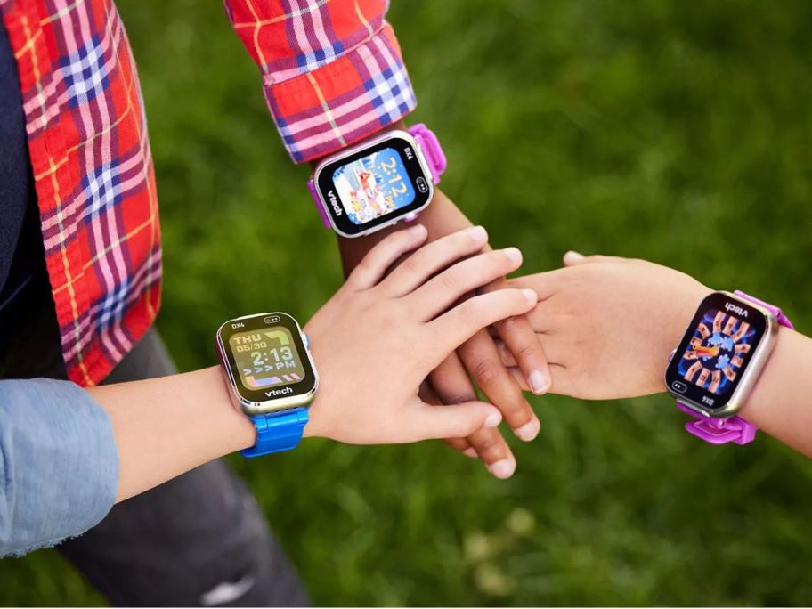 3 Kids with their hands together wearing Vtech Smart Watches