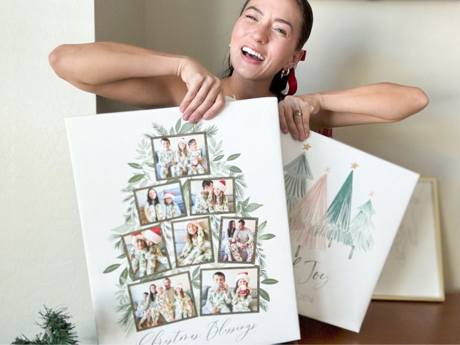 Woman holding two Walgreens holiday photo canvases