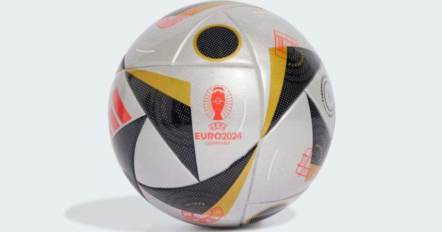 silver, gold, and black soccer ball 