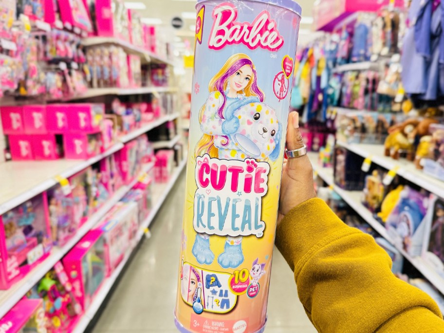 hand holding barbie cutie reveal toy