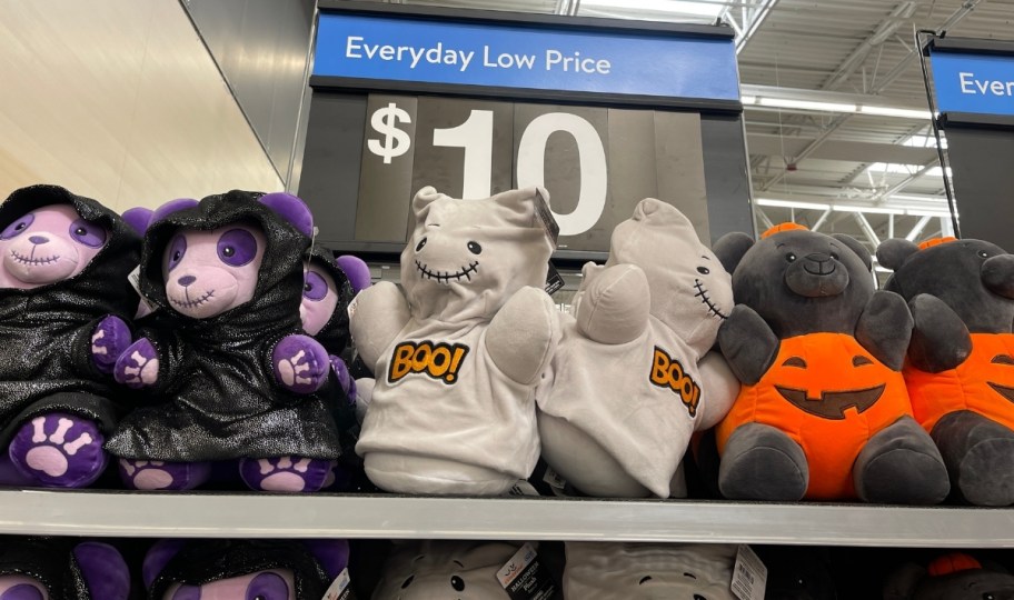 teddy bear halloween plush in costumes on a store shelf