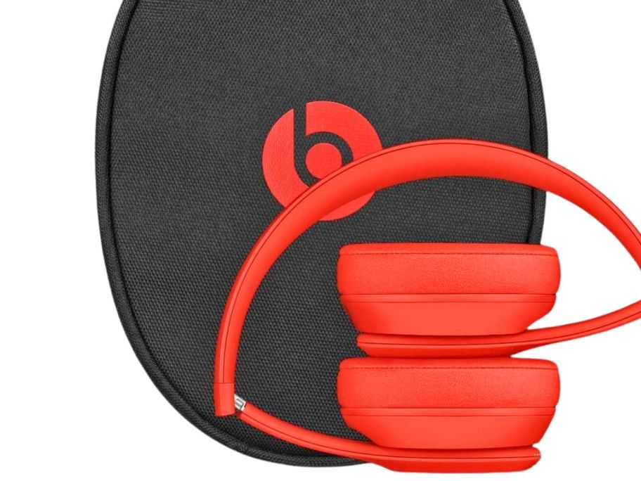 beats headphones folded with case behind it