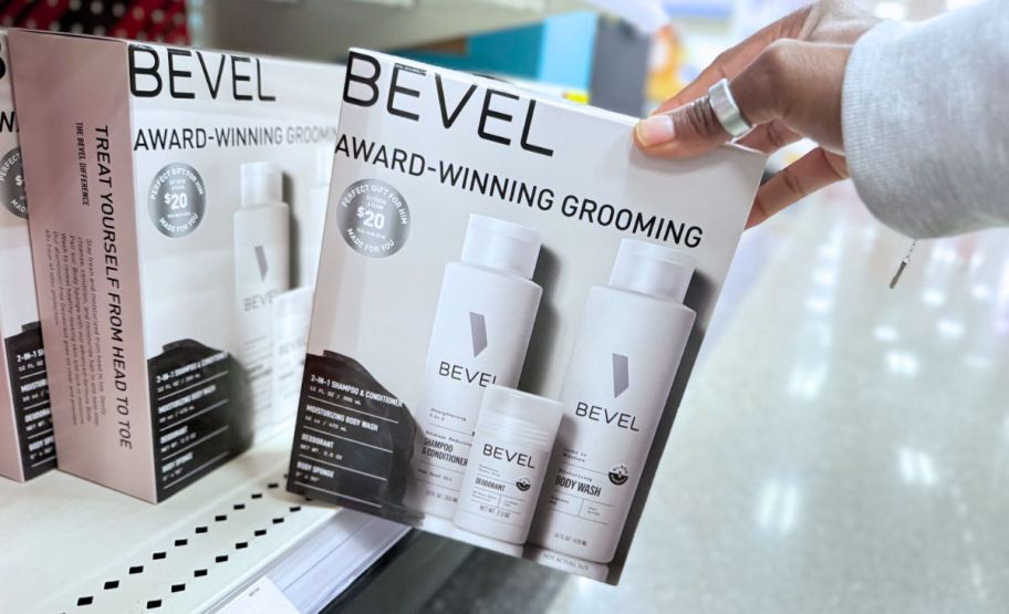 a womans hand grabbing a bevel grooming set form a store shelf