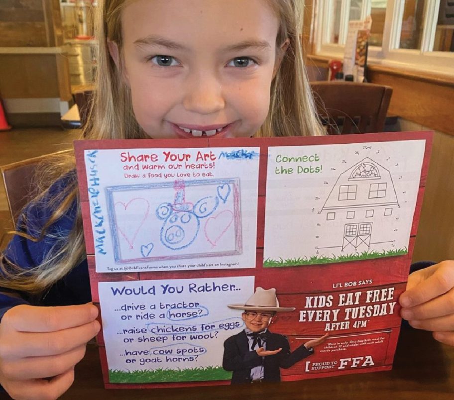 girl holding up a Bob Evans Kids Eat Free promotion