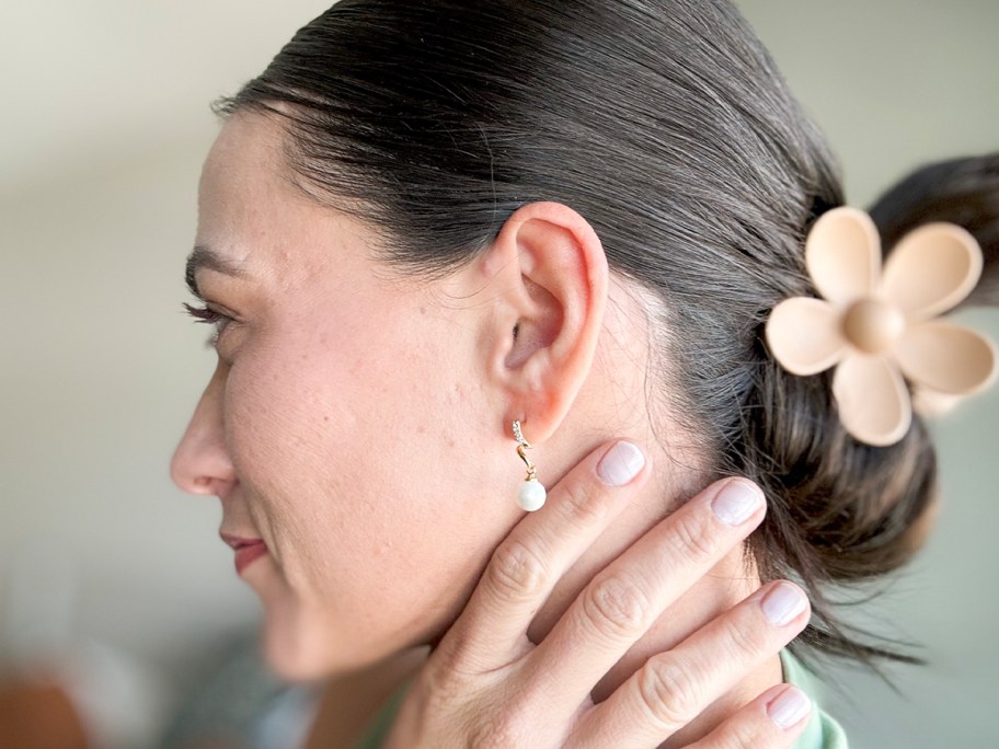 woman wearing drop pearl earrings 